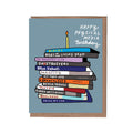 Card with stack of books and birthday candle on a blue background